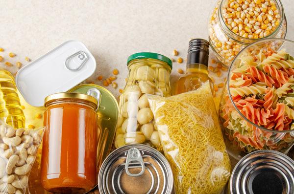 flat lay view at kitchen table full with non perishable foods. s
