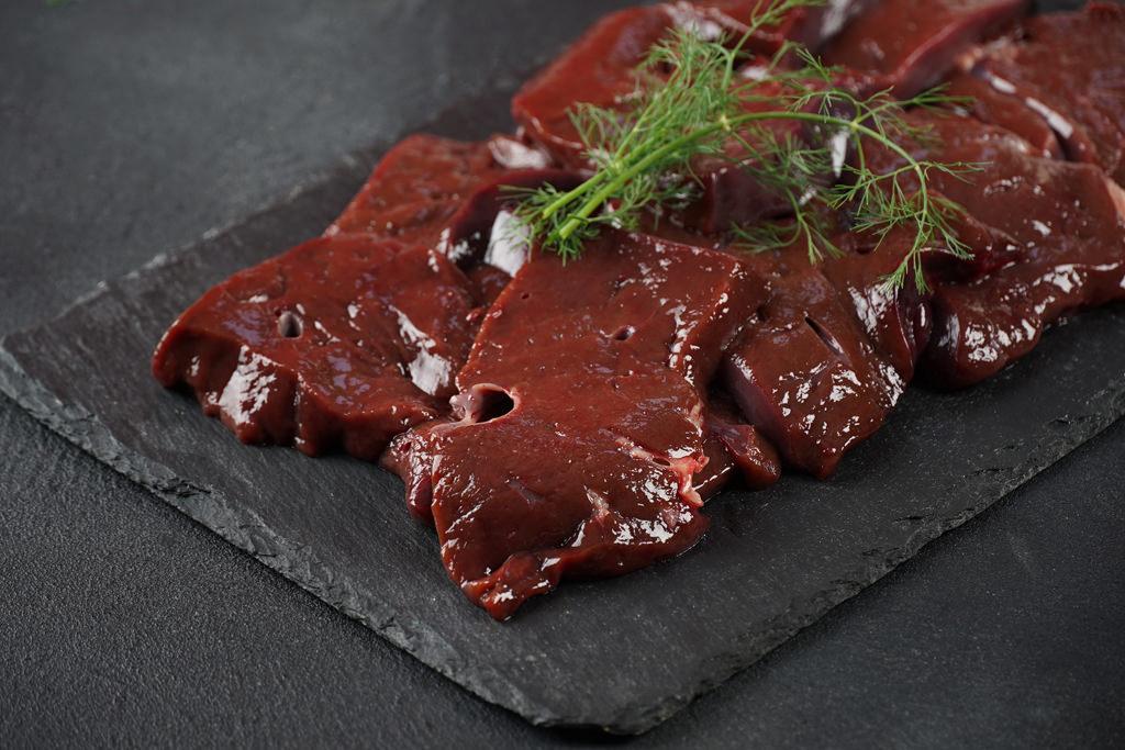 fresh raw beef liver on a slate board